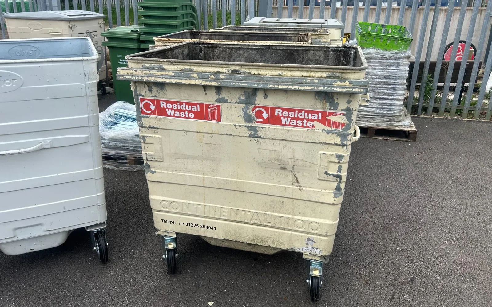 A Taylor Continental 1100L steel wheelie bin before refurbishment showing wear and damage