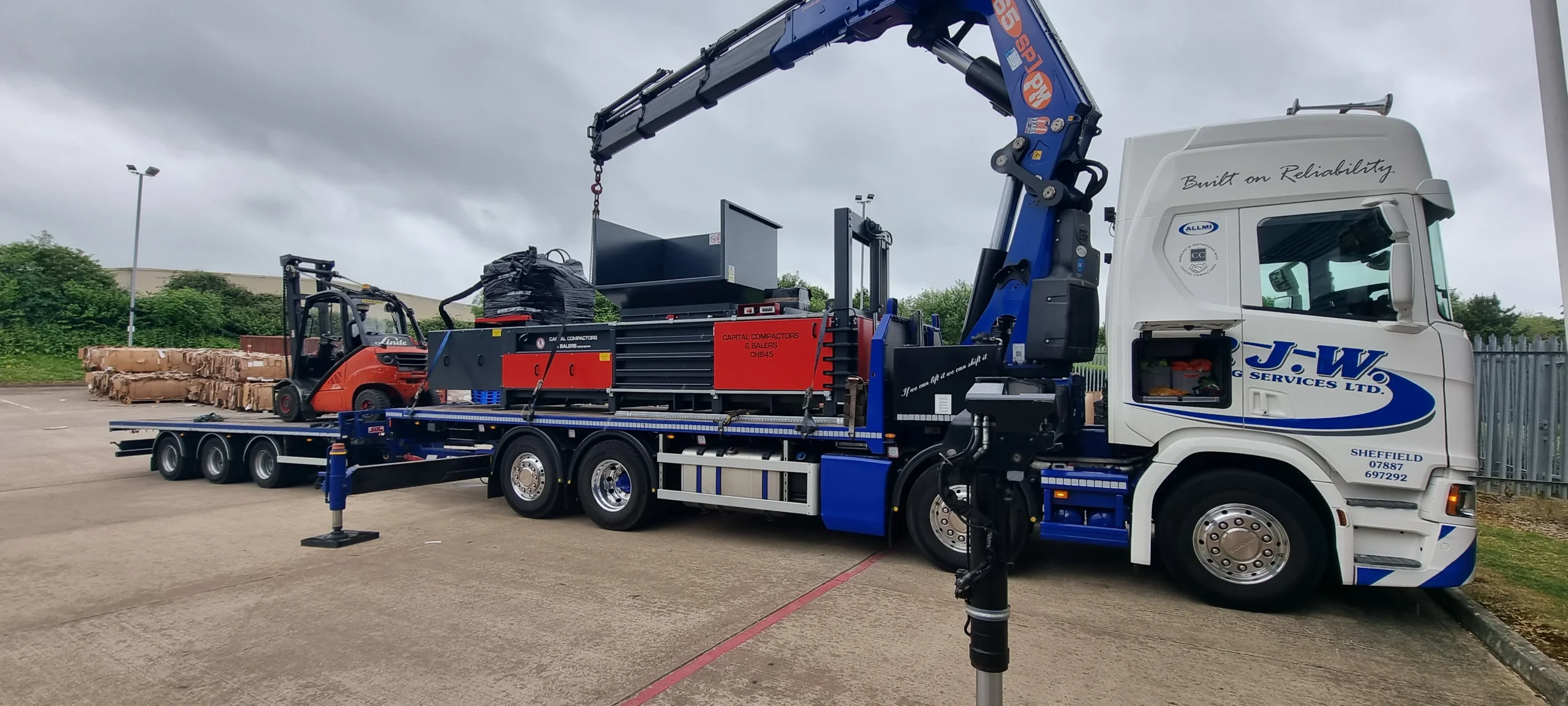 A Capital machine being delivered by crane lorry