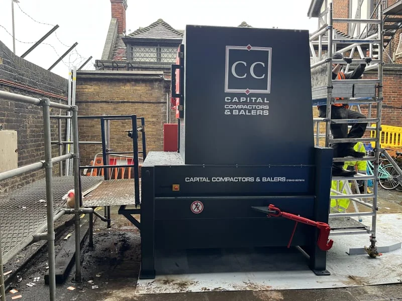 A Capital compactor in a fully enclosed canopy